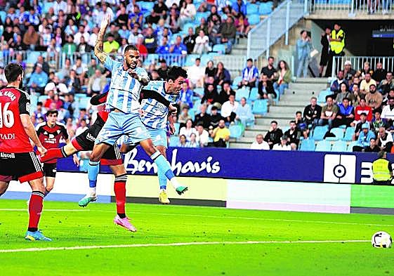 Alberto Escassi, background, gave Malaga an early lead with a powerful header.