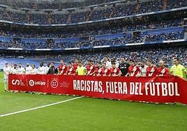 Sign saying 'racists out of football'