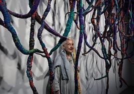 Sheila Hicks with one of her works at the Malaga Pompidou centre.