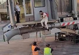 A still from a video captured the moment a man jumped onto the runway at Malaga Airport.