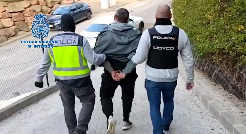 Police officers from the UDYCO unit escort a man arrested for belonging to a criminal gang.