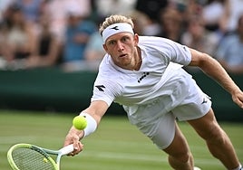 Davidovich throws himself at the ball to hit a shot during the match.