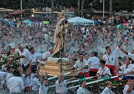 Hundreds of devotees wait in the water for the Virgen del Carmen in El Palo, Malaga