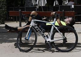 A cyclist rests next to his bicycle today (Monday).