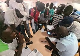 Senegalese filling in CVs for job applications.