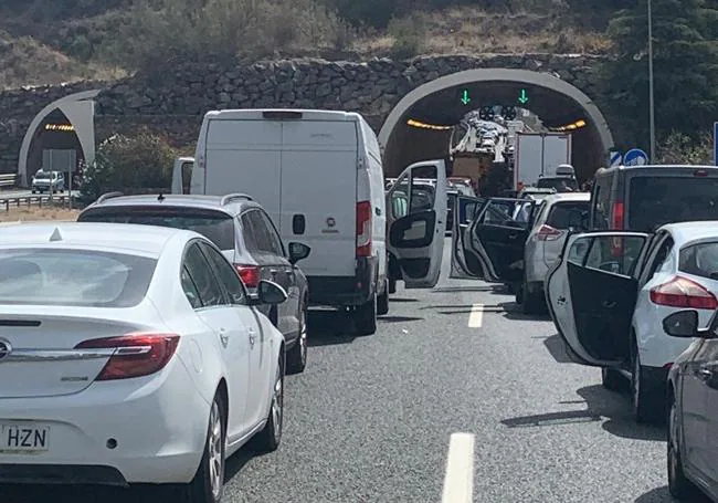 Cars with their doors open in the tailback caused by the incident.