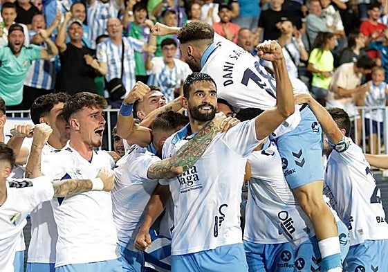 The ecstatic Malaga players savour their last-gasp victory.