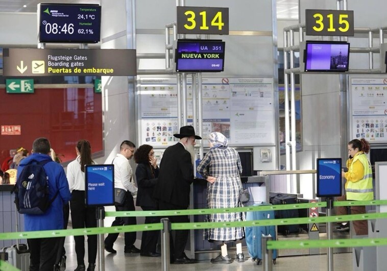 Check-in desk for flights to New York at Malaga Airport.