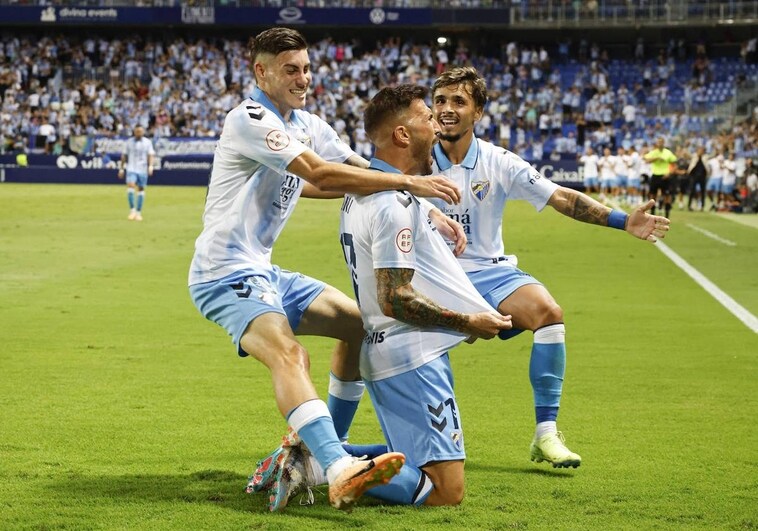 Roberto and Kevin celebrate with Dioni, scorer of the second goal.