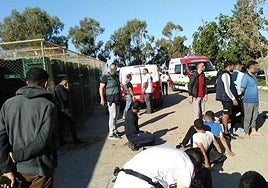 Officers detain some of the immigrants who arrived in Granada on Monday