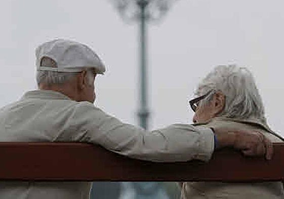 Archive image of a retired couple chatting on a bench.