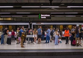 Passengers on a platform at Barcelona's Sants station.
