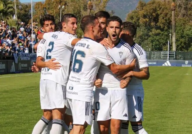 The Marbella players celebrate their late winner.