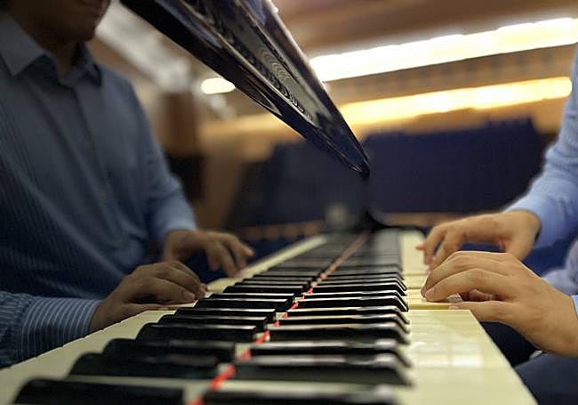 He conducted an orchestra for the first time in public aged 16 at the Edgar Neville Auditorium.