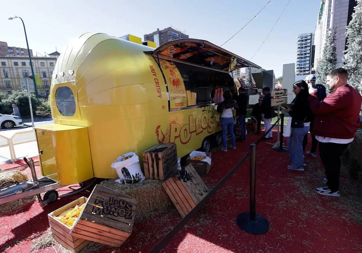 The food truck, painted yellow this year, is parked in front of El Corte Inglés.