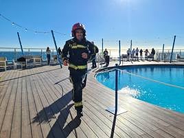 One of the competitors in the endurance competition races around the rooftop pool on the twelfth-floor of the Hotel El Puerto