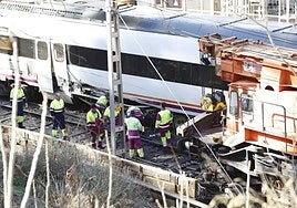 Engineers working to remove the damaged carriages from the track after two trains collided at the station on Saturday evening.