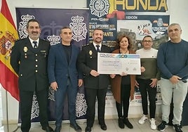 The cheque is delivered to the cancer association.