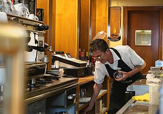 Serving customers in a bar in Madrid.