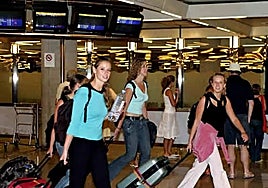 Tourists arrive at an airport.