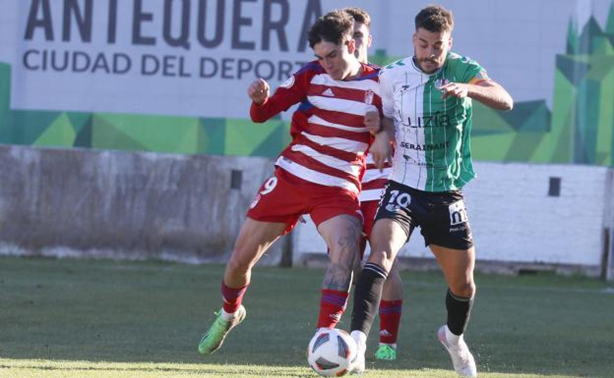 A ball is contested during Antequera's clash with Granada B.