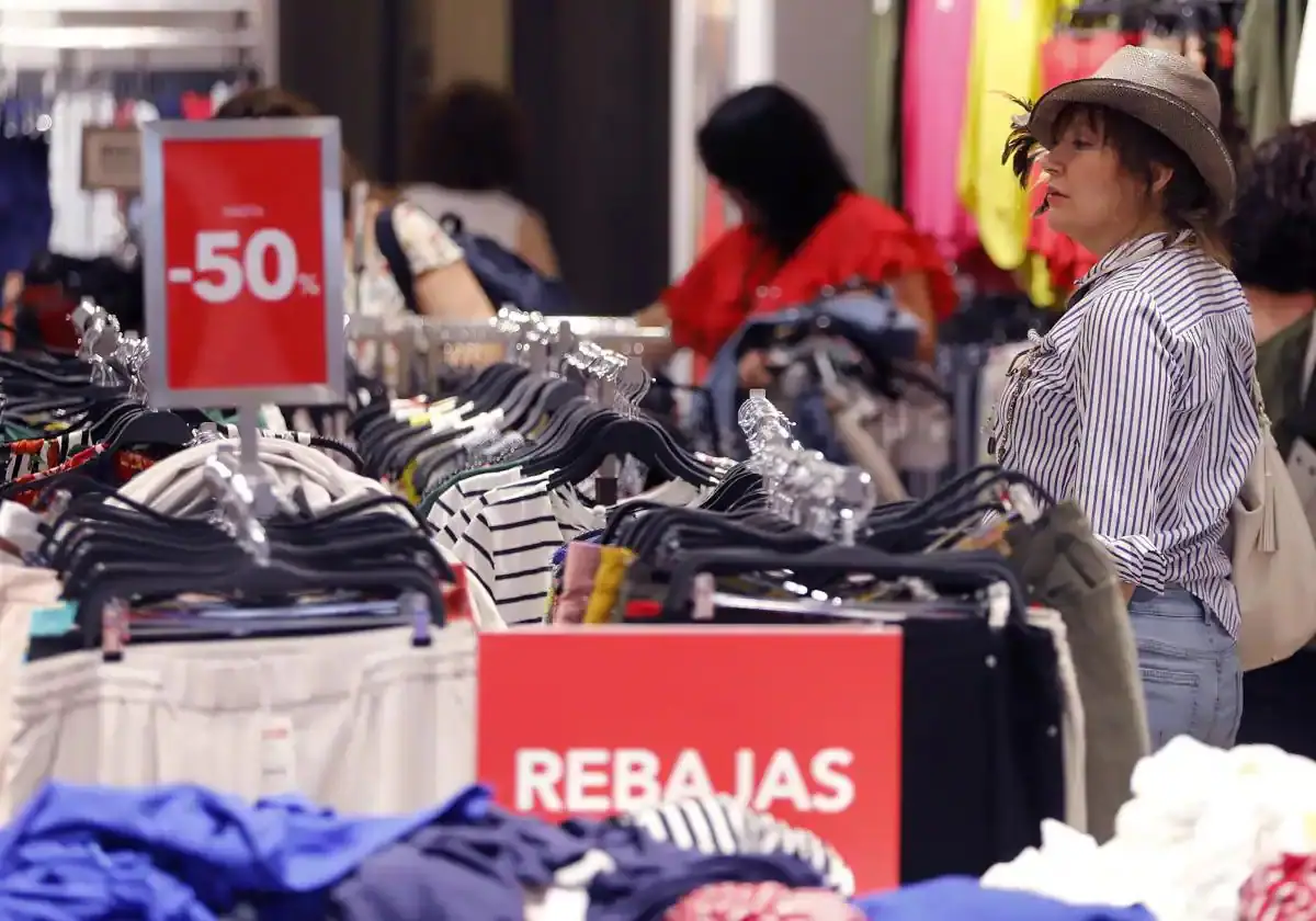 A woman browses through the sales at a large store.