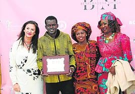 Demba Diop with his family and Rosa González of ACEB.