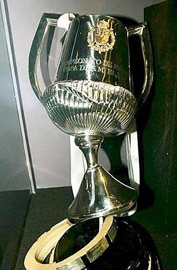 The cup fell under the bus.