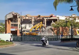 The controlled demolition of the 40-year-old building gets under way.