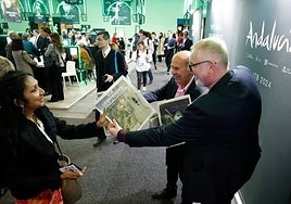 The Andalucía stand at ITB, Berlin, with representatives from SUR handing out a Malaga-produced travel supplement in German.