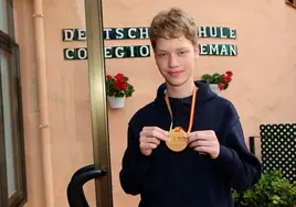 Maxim Dudik with his gold medal outside his school in Marbella.