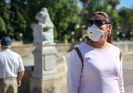 People walk with a mask for their allergy problems in Granada.