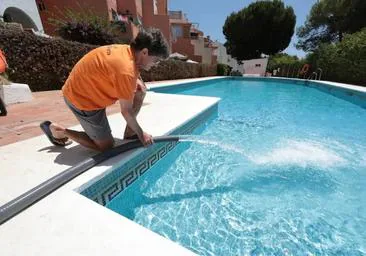 A worker filling a pool with water from a tanker (file image).