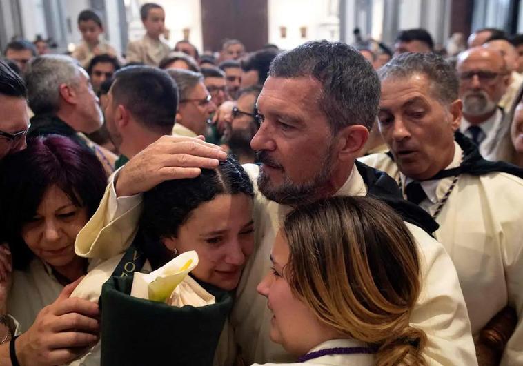 Malaga actor Antonio Banderas consoles fellow members of his brotherhood after their Holy Week procession was cancelled.