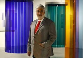 Carlos Cruz Delgado, son of the artist, standing in front of part of the exhibition.