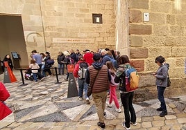 Tourists queue to visit the Picasso Museum in Malaga city.