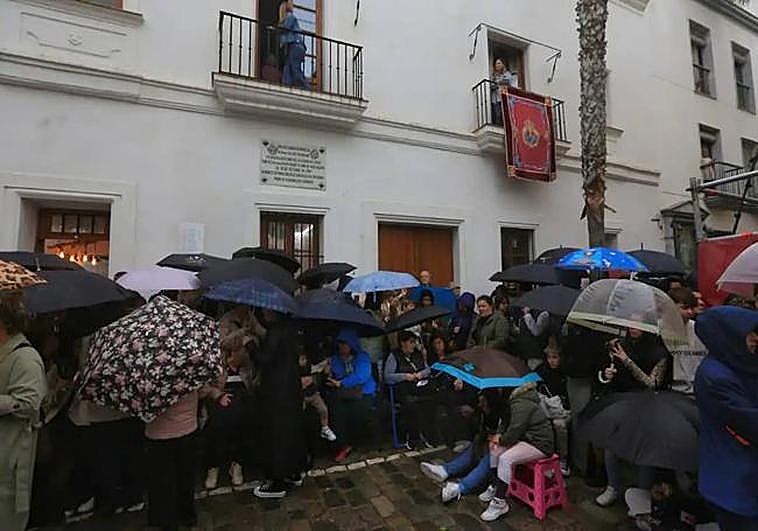 People sat waiting in the rain for the Semana Santa processions.