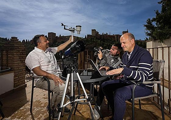 From left to right, Juan, Adrián and Ramón consult weather data from one of their stations in Granada.