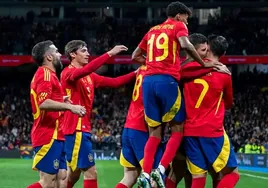 The Spanish players celebrate scoring in a recent game.