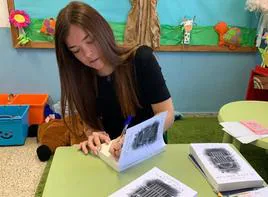 Katie Lewis signs books at her old primary school in Benamargosa.