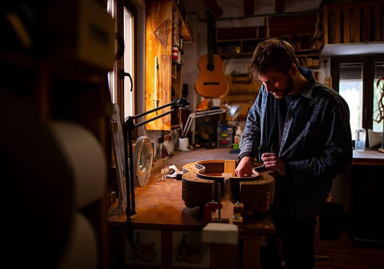 The luthier building a guitar.
