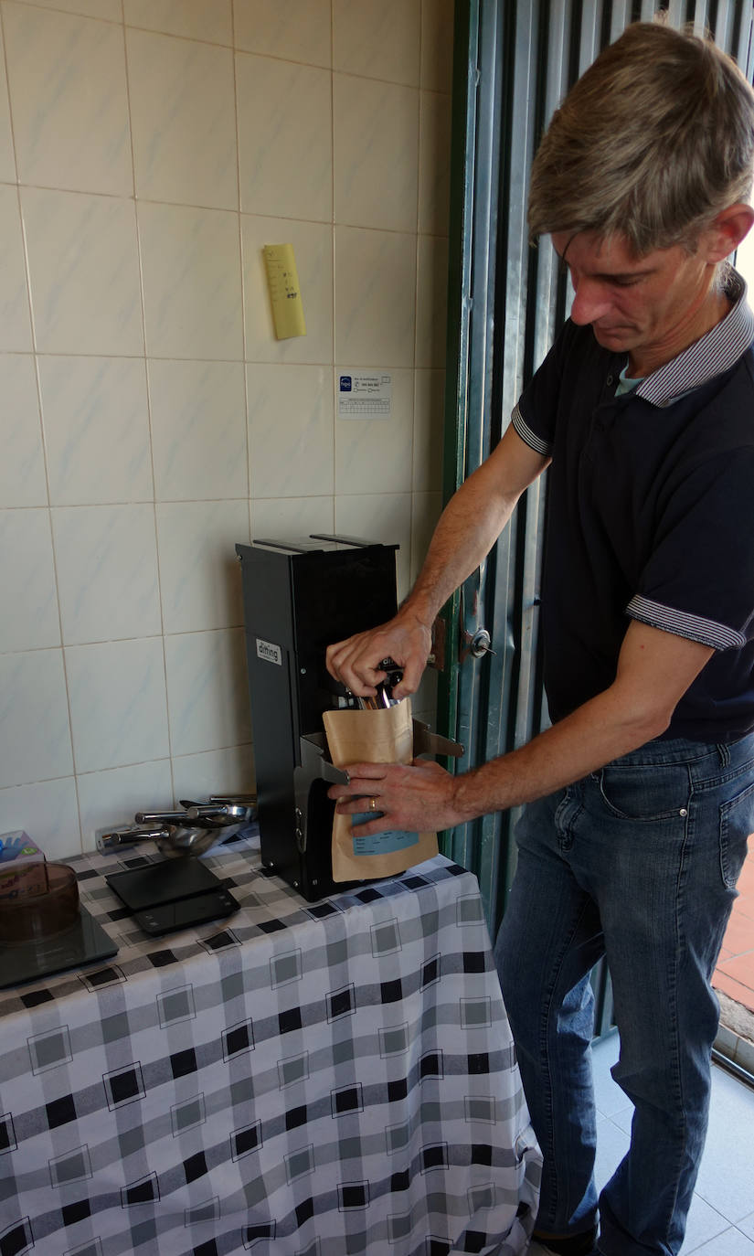 Wesley Patten grinding home-roasted coffee.