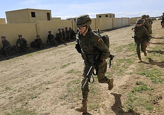 Why has there been an uptick of young women applying to join the army in Spain?