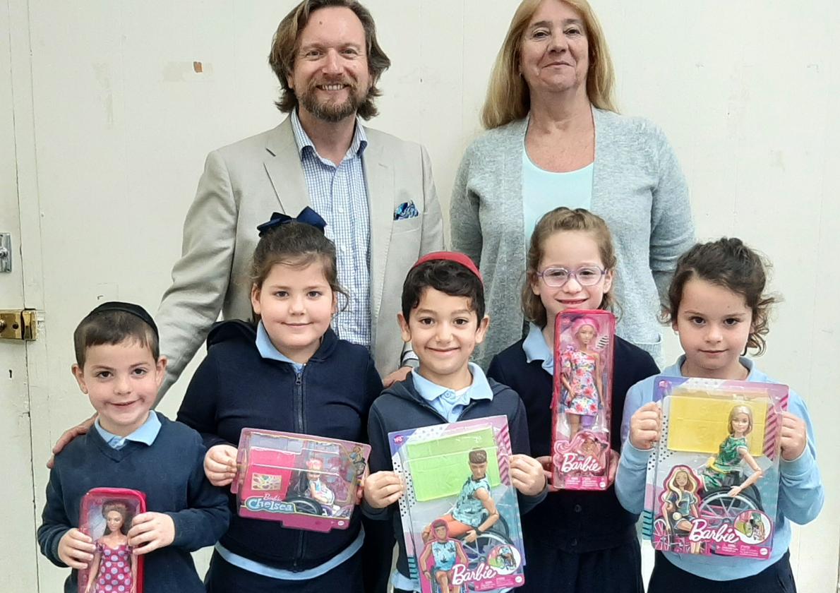 School children holding the disablity dolls.