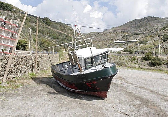 The boat is being stored on land that is used as a car park in summer.