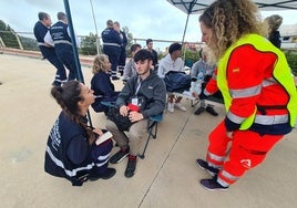 Emergency workers with affected residents during the fire drill.