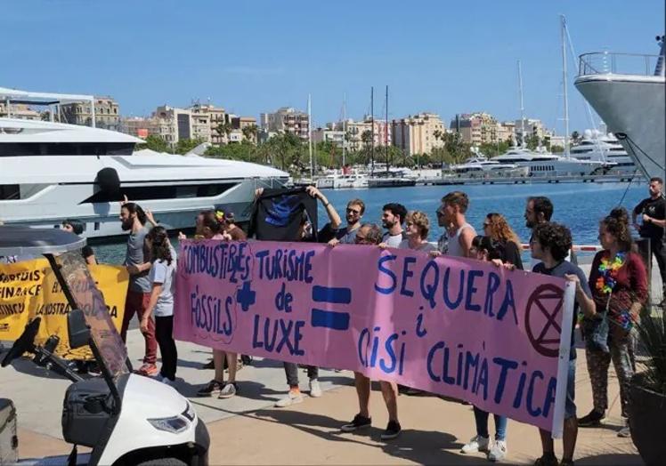 Young activists display their banners in Barcelona's marina.