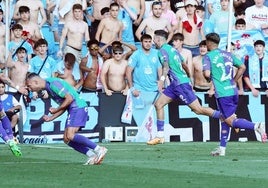 TMalaga players celebrate Roberto's (centre) goal.