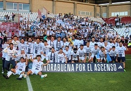 Marbella players celebrate their promotion with the travelling fans.