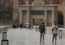 Two people strolling through Arenys de Mar (Barcelona) on Saturday after the heavy downpour that surprised the town.